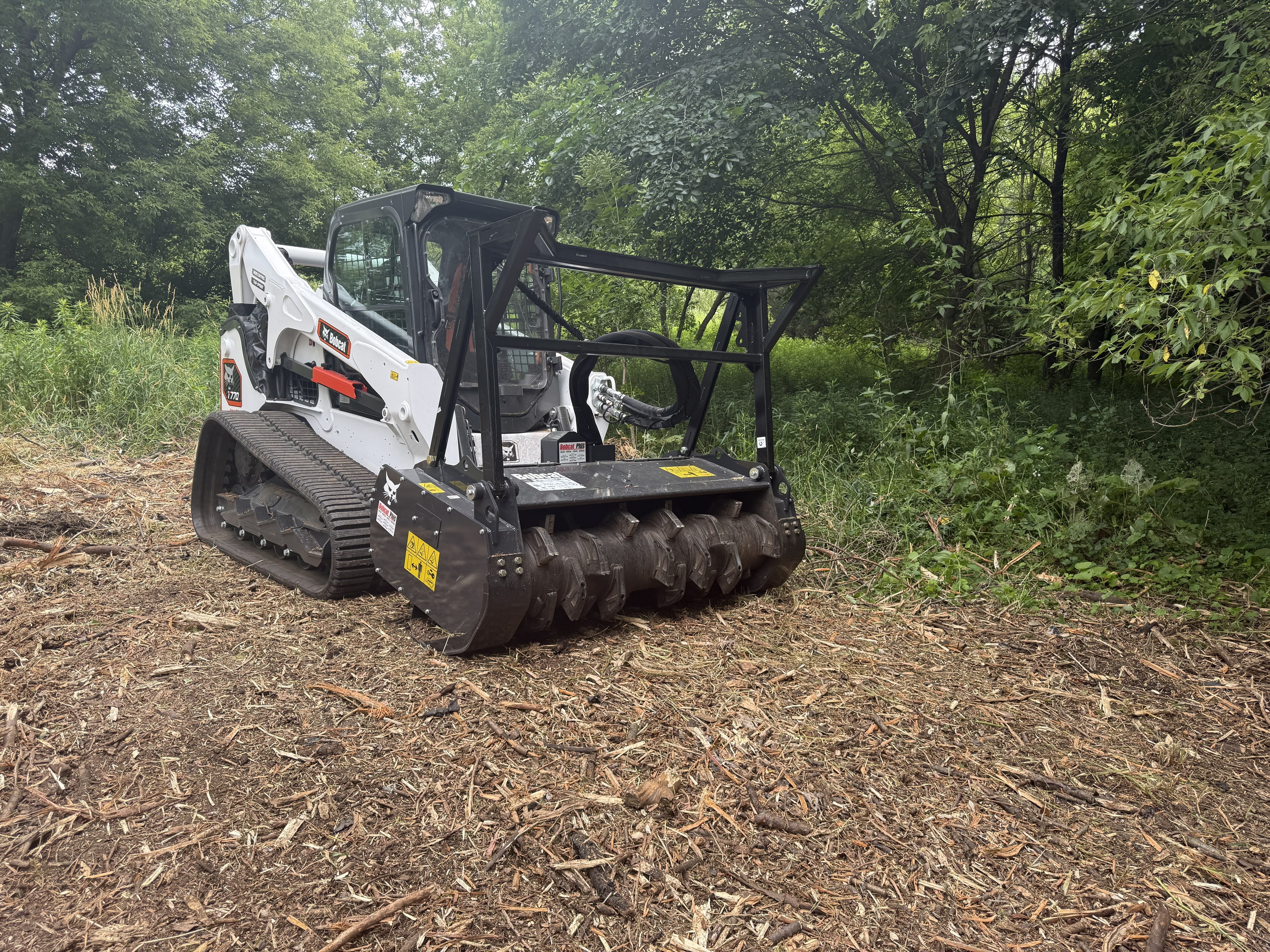 Forestry mulching machine at work clearing wooded land in Wisconsin